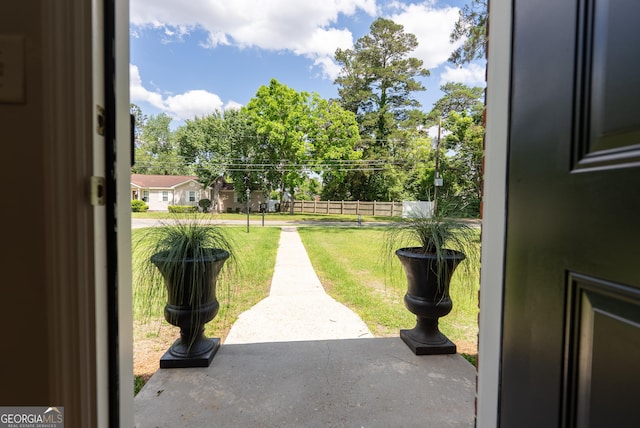view of yard with a patio and view of wooded area