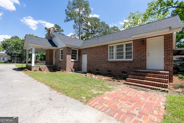 single story home with brick siding, crawl space, entry steps, and a shingled roof
