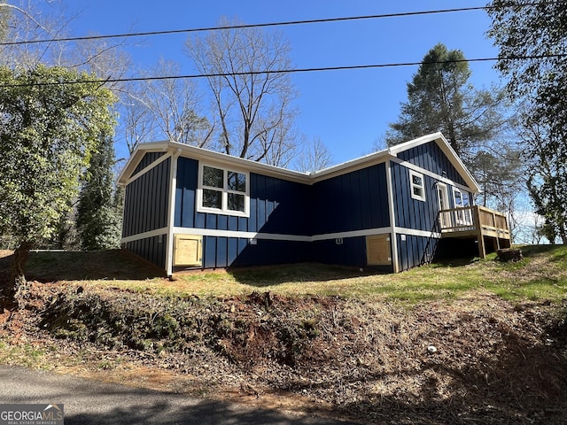 view of front of house featuring board and batten siding and a wooden deck