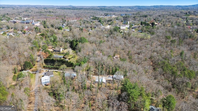 drone / aerial view featuring a view of trees