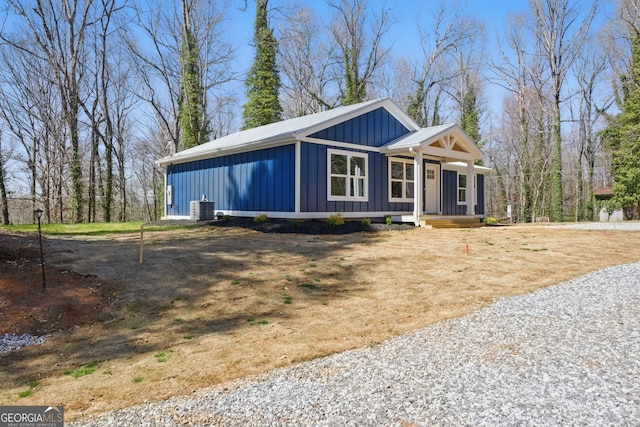 view of front of house with board and batten siding and central AC unit