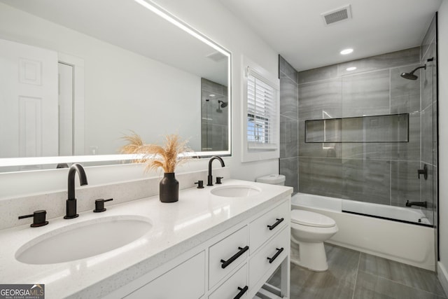 7410 Fields Dr, Cumming, GA 30041 - full bathroom with toilet, visible vents, bath / shower combo with glass door, and a sink