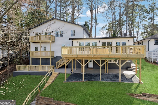 7410 Fields Dr, Cumming, GA 30041 - back of house with stairway, a lawn, and a deck