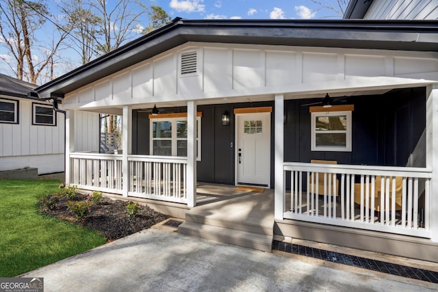 7410 Fields Dr, Cumming, GA 30041 - view of exterior entry featuring a porch, a ceiling fan, and board and batten siding