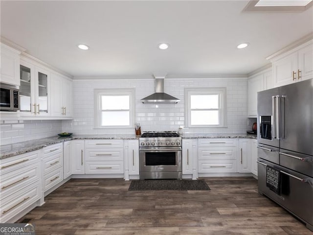 6041 Blackberry Ln, Buford, GA 30518 - kitchen with high quality appliances, wall chimney exhaust hood, backsplash, plenty of natural light, and recessed lighting