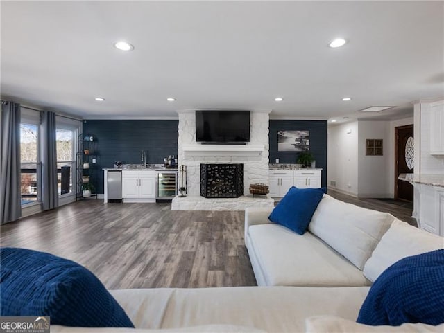 6041 Blackberry Ln, Buford, GA 30518 - living area featuring wine cooler, baseboards, recessed lighting, ornamental molding, and wood finished floors