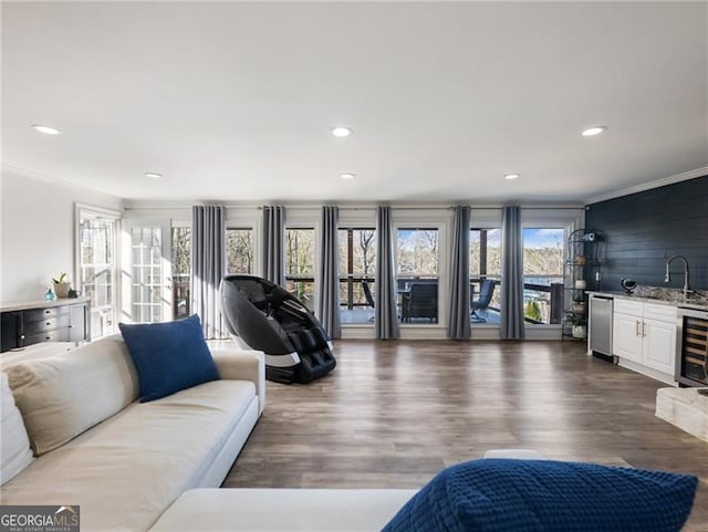 6041 Blackberry Ln, Buford, GA 30518 - living area featuring crown molding, plenty of natural light, bar, beverage cooler, and wood finished floors