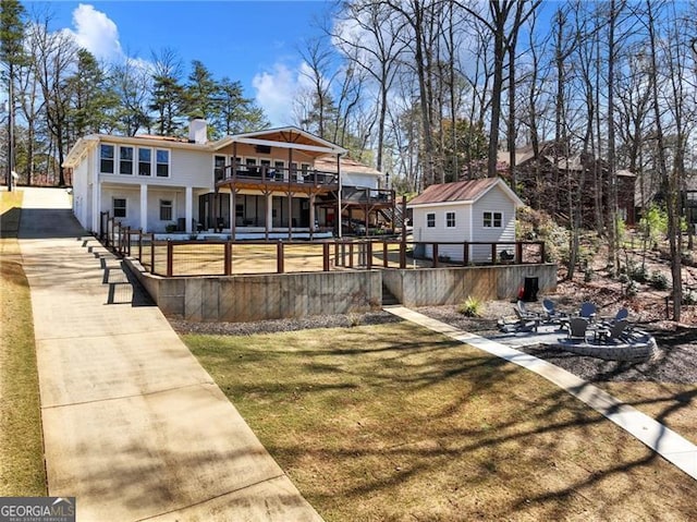 6041 Blackberry Ln, Buford, GA 30518 - rear view of property featuring a lawn, a deck, a patio area, and a chimney