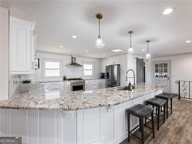 6041 Blackberry Ln, Buford, GA 30518 - kitchen with a sink, wall chimney range hood, stainless steel appliances, decorative backsplash, and white cabinets