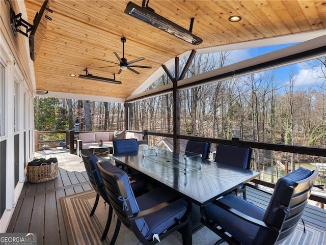 6041 Blackberry Ln, Buford, GA 30518 - wooden deck featuring ceiling fan, view of wooded area, and outdoor dining space
