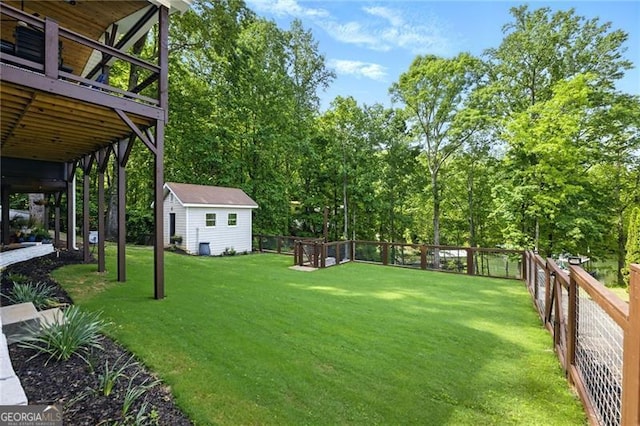 6041 Blackberry Ln, Buford, GA 30518 - view of yard with an outbuilding, a wooden deck, and view of wooded area