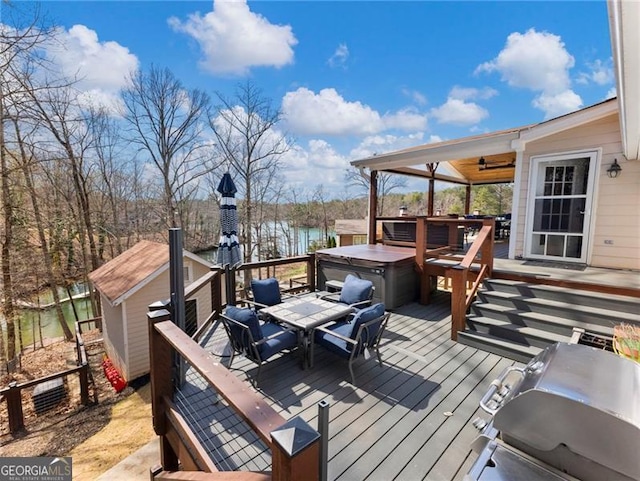 6041 Blackberry Ln, Buford, GA 30518 - deck featuring a hot tub, a water view, outdoor dining space, and a ceiling fan