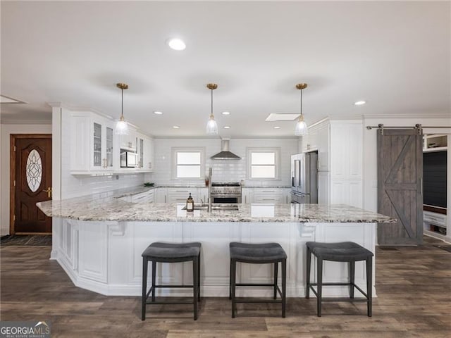 6041 Blackberry Ln, Buford, GA 30518 - kitchen featuring high quality appliances, a barn door, white cabinetry, backsplash, and recessed lighting