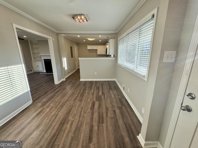 1380 Margarette Dr, Decatur, GA 30035 - unfurnished dining area featuring baseboards, dark wood-type flooring, a fireplace with raised hearth, and crown molding