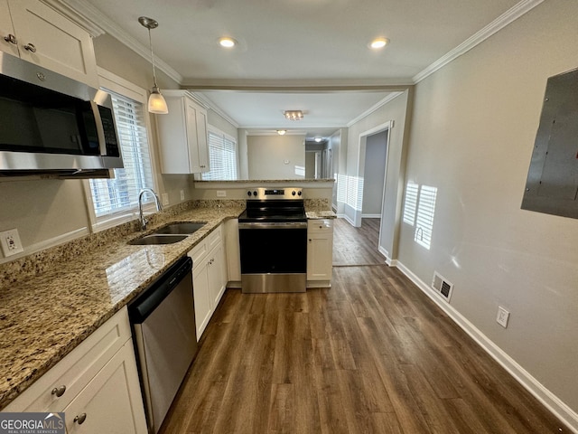 1380 Margarette Dr, Decatur, GA 30035 - kitchen with ornamental molding, a sink, dark wood finished floors, stainless steel appliances, and white cabinets