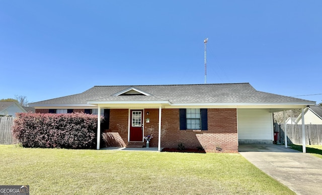 5612 Hickory Dr, Patterson, GA 31557 - ranch-style home featuring brick siding, a front lawn, fence, concrete driveway, and a carport