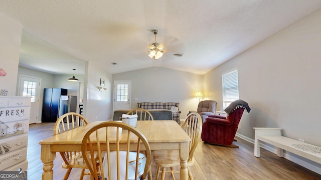 5612 Hickory Dr, Patterson, GA 31557 - dining room with light wood-style flooring, lofted ceiling, ceiling fan, and a healthy amount of sunlight