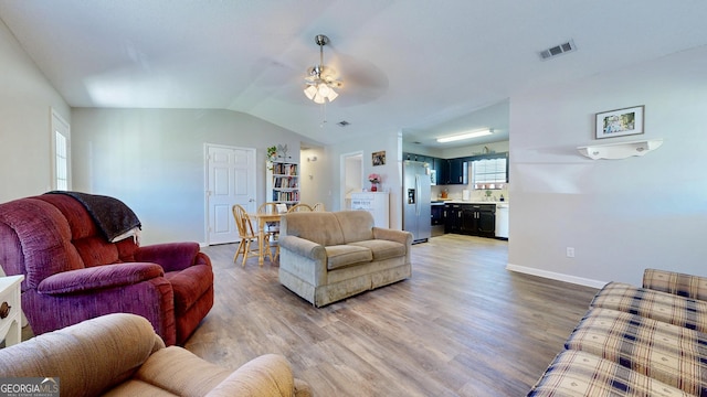 5612 Hickory Dr, Patterson, GA 31557 - living area featuring visible vents, baseboards, light wood-style floors, lofted ceiling, and ceiling fan