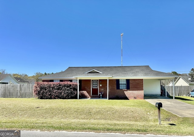 5612 Hickory Dr, Patterson, GA 31557 - ranch-style house featuring driveway, a carport, fence, a front yard, and brick siding