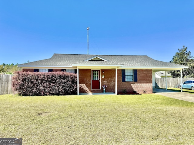 5612 Hickory Dr, Patterson, GA 31557 - single story home featuring an attached carport, fence, concrete driveway, a front yard, and brick siding