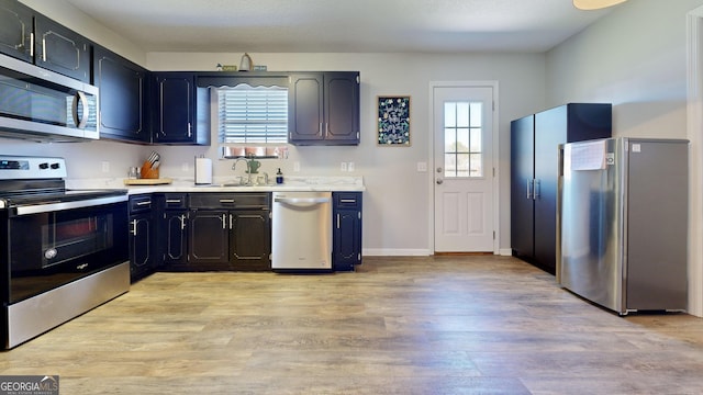 5612 Hickory Dr, Patterson, GA 31557 - kitchen featuring a sink, light wood-type flooring, appliances with stainless steel finishes, and light countertops