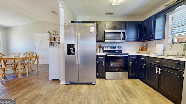 5612 Hickory Dr, Patterson, GA 31557 - kitchen with visible vents, a sink, stainless steel appliances, light wood finished floors, and light countertops