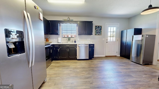 5612 Hickory Dr, Patterson, GA 31557 - kitchen featuring a sink, stainless steel appliances, light countertops, a textured ceiling, and light wood-type flooring