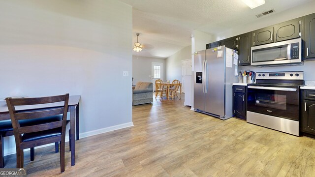 5612 Hickory Dr, Patterson, GA 31557 - kitchen with light wood finished floors, visible vents, ceiling fan, light countertops, and stainless steel appliances