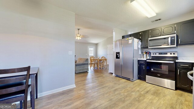 5612 Hickory Dr, Patterson, GA 31557 - kitchen with visible vents, light countertops, light wood-style flooring, appliances with stainless steel finishes, and a ceiling fan