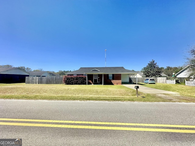5612 Hickory Dr, Patterson, GA 31557 - ranch-style home with a carport, concrete driveway, a front yard, and fence