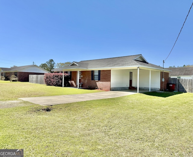 5612 Hickory Dr, Patterson, GA 31557 - view of front of property with an attached carport, brick siding, a front yard, and fence