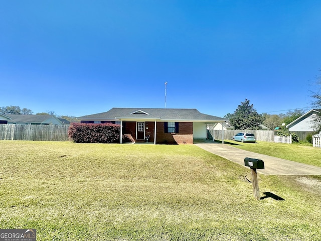 5612 Hickory Dr, Patterson, GA 31557 - single story home featuring a front yard, fence, a carport, concrete driveway, and brick siding