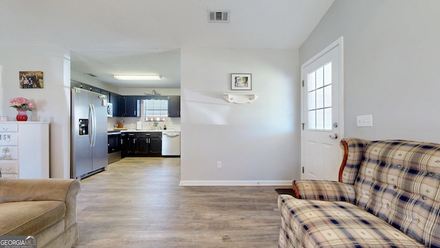 5612 Hickory Dr, Patterson, GA 31557 - living room with visible vents, light wood-style flooring, and baseboards