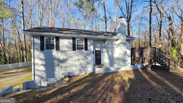 2172 Nancy Way, Loganville, GA 30052 - view of front of house with stucco siding, a chimney, and stairway