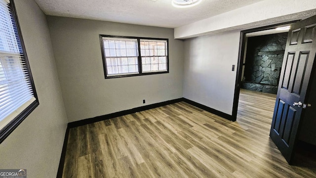 2172 Nancy Way, Loganville, GA 30052 - empty room featuring a textured ceiling, baseboards, and wood finished floors