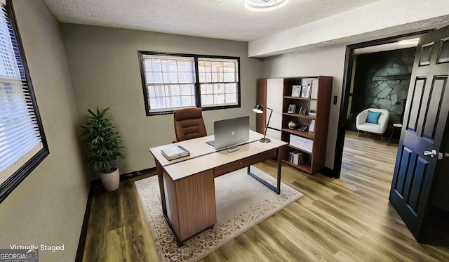 2172 Nancy Way, Loganville, GA 30052 - home office with a textured ceiling and light wood-style floors