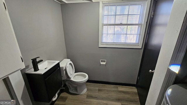 2172 Nancy Way, Loganville, GA 30052 - half bath with toilet, wood finished floors, and vanity