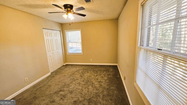 2172 Nancy Way, Loganville, GA 30052 - unfurnished bedroom featuring baseboards, carpet floors, a textured ceiling, and a closet