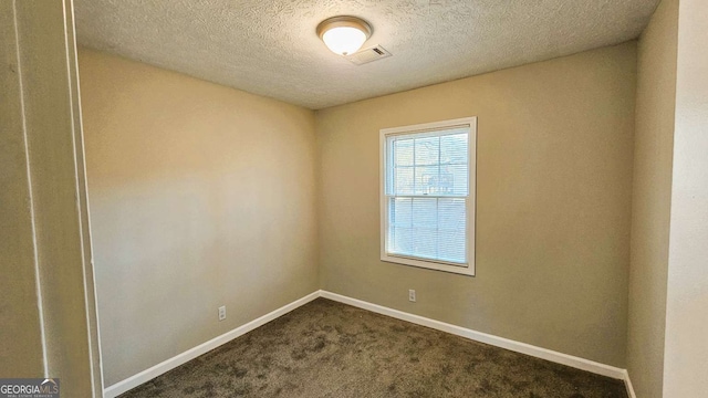 2172 Nancy Way, Loganville, GA 30052 - unfurnished room with visible vents, dark carpet, a textured ceiling, and baseboards