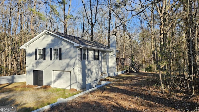 2172 Nancy Way, Loganville, GA 30052 - view of side of property featuring stairway, driveway, and an attached garage