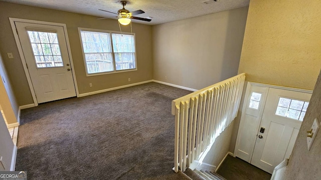 2172 Nancy Way, Loganville, GA 30052 - entryway with baseboards, a textured ceiling, ceiling fan, and dark carpet