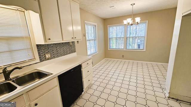 2172 Nancy Way, Loganville, GA 30052 - kitchen featuring a sink, decorative backsplash, light countertops, black dishwasher, and a chandelier