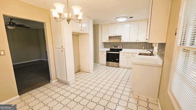 2172 Nancy Way, Loganville, GA 30052 - kitchen with stainless steel electric range oven, light floors, light countertops, under cabinet range hood, and white cabinetry