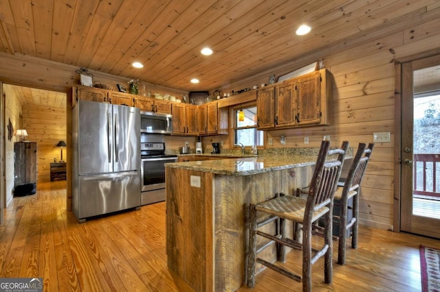 65 Weoka Ct, Ellijay, GA 30540 - kitchen featuring stainless steel appliances, a peninsula, healthy amount of natural light, brown cabinets, and wood ceiling
