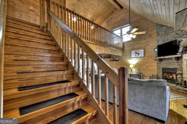 65 Weoka Ct, Ellijay, GA 30540 - staircase featuring a fireplace, ceiling fan, high vaulted ceiling, wood finished floors, and beam ceiling