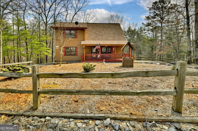 65 Weoka Ct, Ellijay, GA 30540 - view of front of house with a porch, a fenced front yard, and roof with shingles