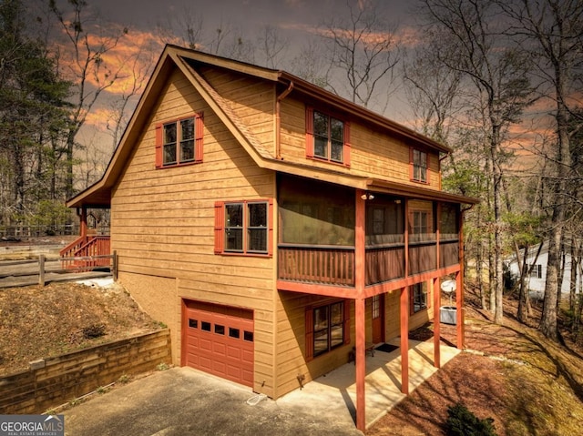 65 Weoka Ct, Ellijay, GA 30540 - back of property with an attached garage, driveway, and cooling unit