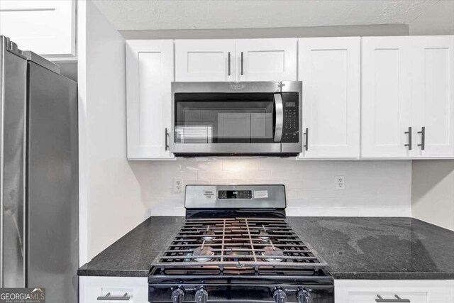 2478 Verbena Cir NW, Atlanta, GA 30314 - kitchen featuring white cabinetry, decorative backsplash, and stainless steel appliances