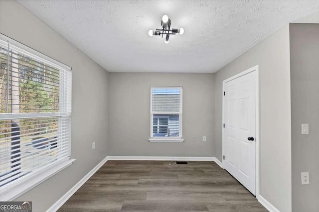 2478 Verbena Cir NW, Atlanta, GA 30314 - unfurnished room with wood finished floors, baseboards, and a textured ceiling