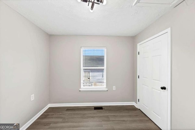2478 Verbena Cir NW, Atlanta, GA 30314 - unfurnished room featuring visible vents, a textured ceiling, baseboards, and wood finished floors